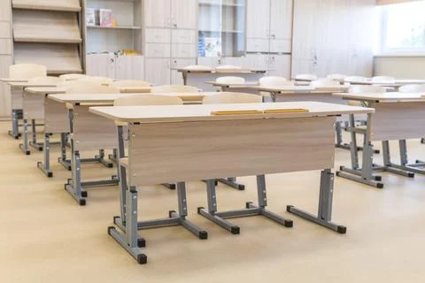 School classroom closed in background without young student, school desks Stock Photos