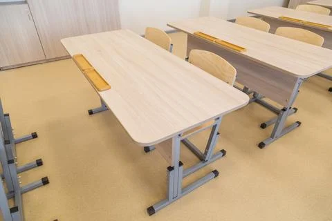 School classroom closed in background without young student, school desks Stock Photos