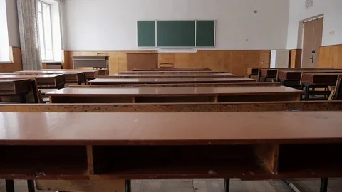 School classroom with outworn desks, old wooden chairs and chalkboard Stock Footage 73304585