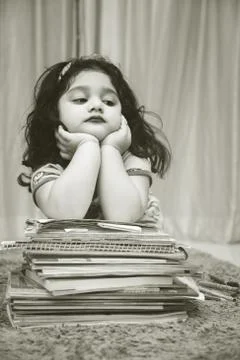 School Closures And Lockdown. Bored Schoolgirl With Pile Of Books studying on Stock Photos