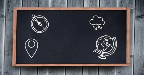 In school, a compass, rain cloud, and globe are drawn on the blackboard Stock Photos