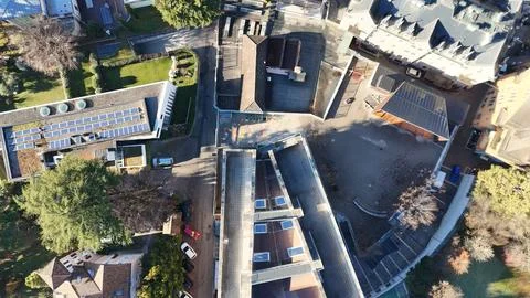 School complex with courtyard, playground and surrounding residential build.. Stock Photos