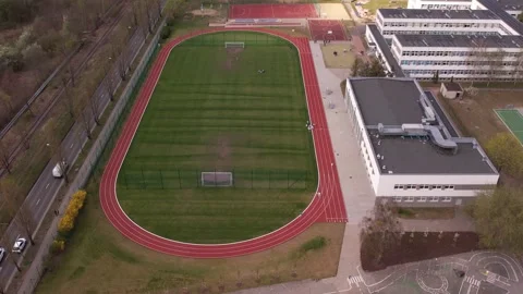 School Complex with Sports Fields and Urban Landscape - Aerial View 스톡 동영상 307058693