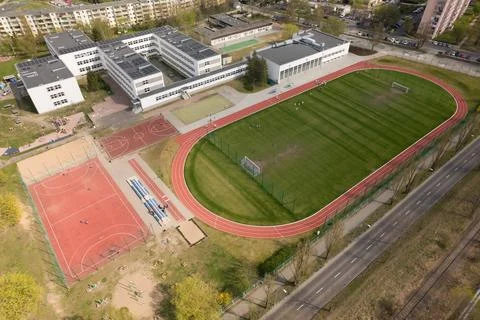 School Complex with Sports Fields and Urban Landscape - Aerial View Stock Photos