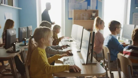 School Computer Classroom: Teacher Uses Tablet Computer, Explains Lesson to Kids Stock Footage 119360100