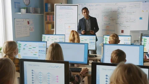 School Computer Classroom: Teacher Uses Tablet Computer, Explains Lesson to Kids Stock Footage 119360368