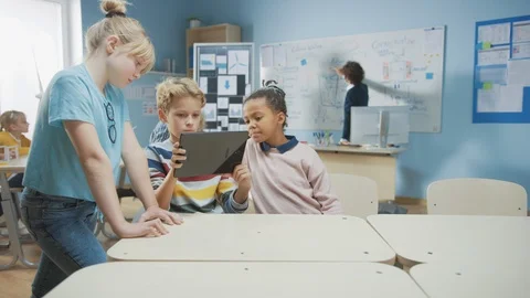 School Computer Science Class: Two Girls and A Boy Use Digital Tablet with AR 스톡 동영상 119056442