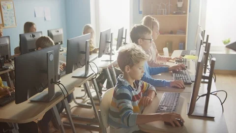 School Computer Science Classroom: Group of Little Smart Schoolchildren using PC Stock Footage 119359983