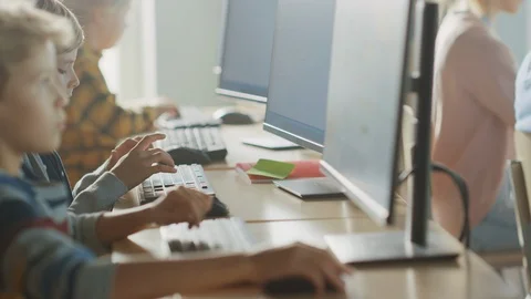 School Computer Science Classroom: Smart Little Schoolchildren Work on PC Stock Footage 119359507