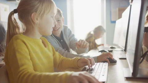 School Computer Science Classroom: Smart Girl and Boy Talking While Using PC 스톡 동영상 119360346