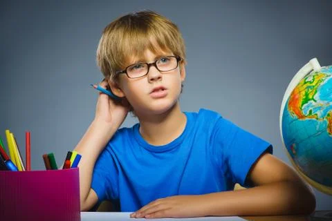 School concept. doubt, expression - boy thinking over gray background Stock Photos