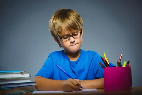 School concept. doubt, expression - boy thinking over gray background Stock Photos