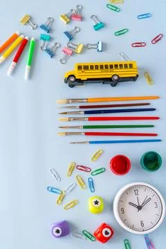 School concept layout with multicolored pens bright yellow toy bus and wax .. Stock Photos