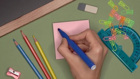 School concept. Womans hand writing YOU ARE THE BEST TEACHER on notepad Stock Footage 99036044