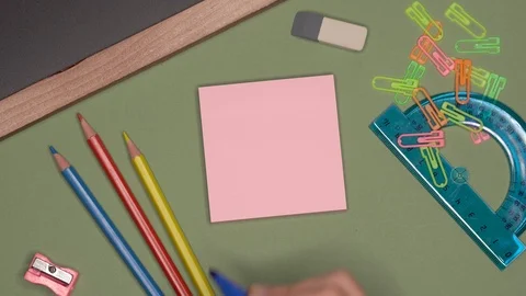 School concept. Womans hand writing HELLO on notepad Stock Footage 99730906