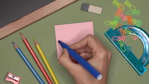 School concept. Womans hand writing WELCOME on notepad Stock Footage 99783669