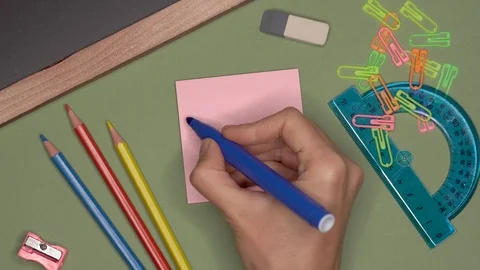 School concept. Womans hand writing LITERACY DAY on notepad Stock Footage 99784012