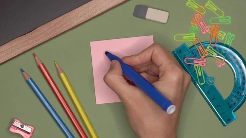 School concept. Womans hand writing FOCUS GOOD THINGS on notepad Stock Footage 99972595