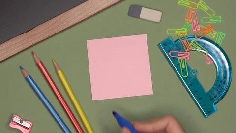 School concept. Womans hand writing BE CREATIVE on notepad Stock Footage 99982845