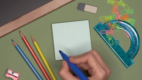 School concept. Womans hand writing LEARN on notepad Stock Footage 100109482