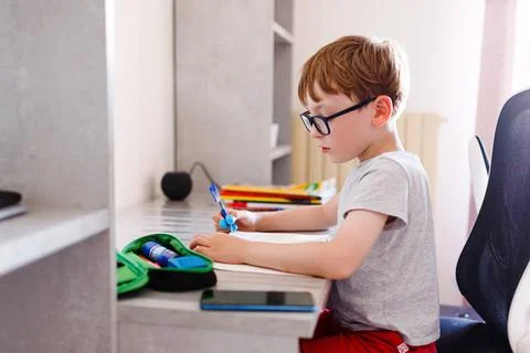 School DAYS. Random kin doing his homework Stock Photos