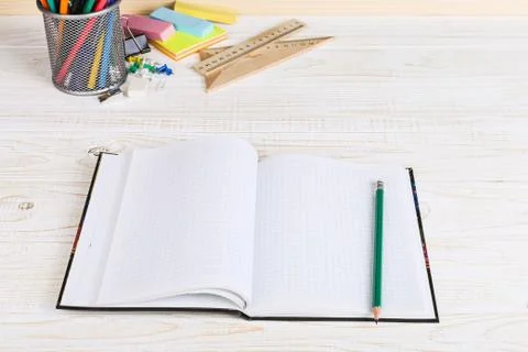 School desk in class, with notebook and pencil. Concept teacher's day. Stock Photos