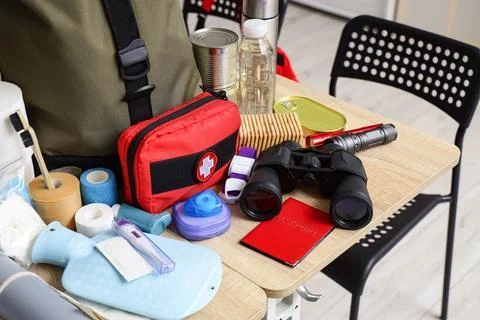 School desks with emergency backpack, first aid kit and necessities in classr Stock Photos