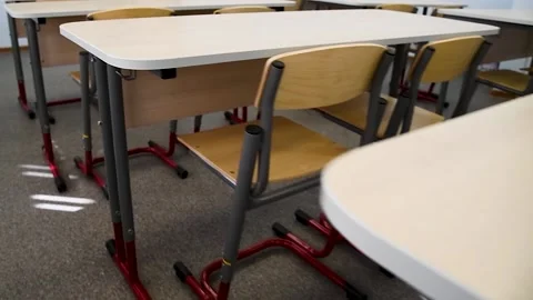 School desks in a row facing the blackboard in an empty classroom Stock Footage 220618489