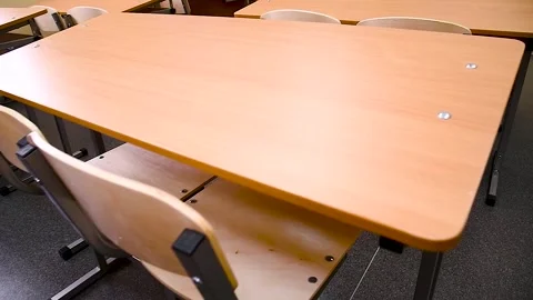 School desks in a row facing the blackboard in an empty classroom Stock Footage 310052372
