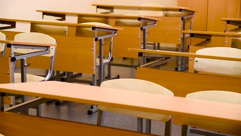 School desks in a row facing the blackboard in an empty classroom Stock Footage 310052375