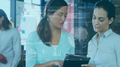 In school, discussing data with digital analytics overlay, two women using Stock Footage 330058902