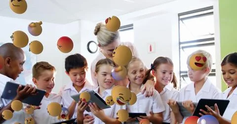In school, diverse students and teacher using tablets with floating emojis Stock Illustration