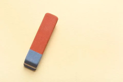 School eraser on light yellow background 库存照片
