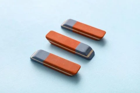 School erasers on blue background Stock Photos