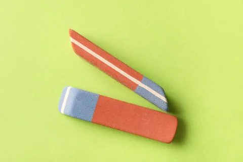 School erasers on green background Stock Photos