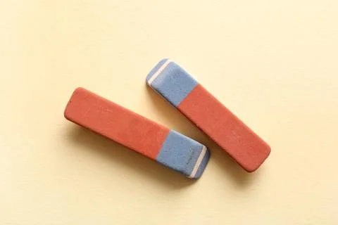 School erasers on light yellow background Stock Photos