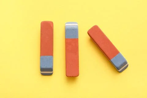 School erasers on yellow background 库存照片