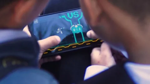 School friends play on the same smartphone. Stock Footage 254270356