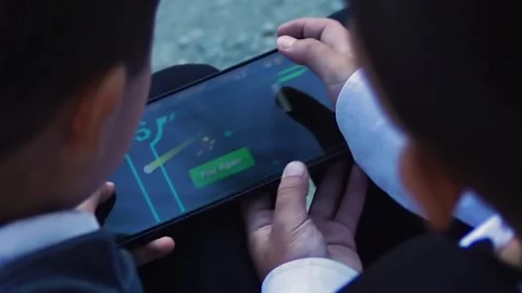 School friends play on the same smartphone. Stock Footage 254270357