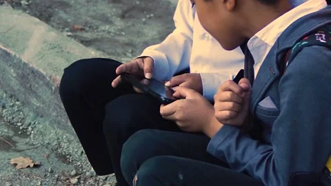 School friends play on the same smartphone. Stock Footage 254270370