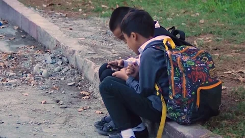 School friends play on the same smartphone. Stock Footage 254270382