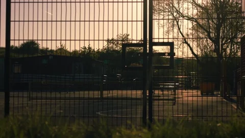 School gates with playground at dusk Видео 333527530