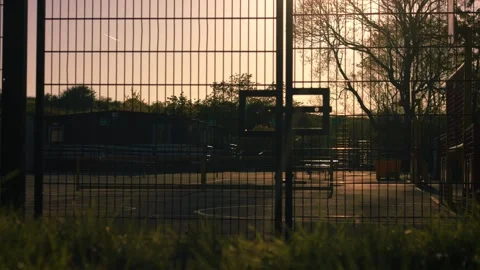 School gates with playground at dusk Stock Footage 334219109