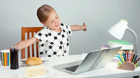 School girl 7-8 years stretching and making sandwich with butter and jam Stock Footage