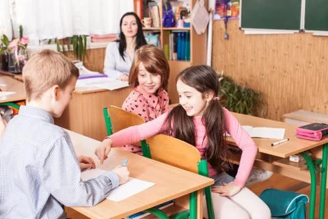School girl explaining her classmate Stock Photos