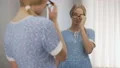 School girl taking off glasses and smiling to mirror, turning in beautiful lady 4k or 4k+ Resolution