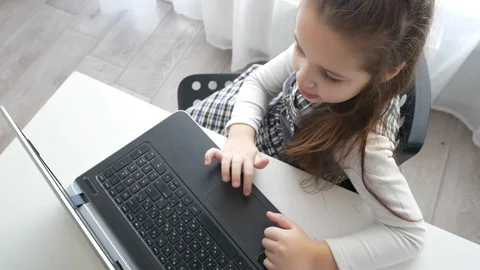 School girl using laptop computer to type something Stock Footage 105921546