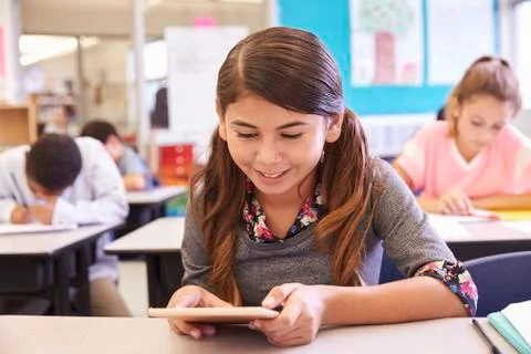 School girl using tablet computer in elementary school class Stock Photos