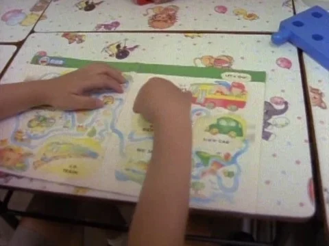 School girls having a fun time as they sit around the table enjoying their books Stock Footage 79878852