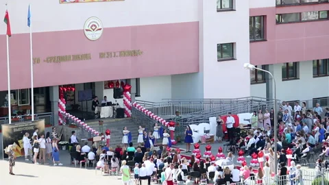 School Graduation Celebration. Junior students sing and dance in front of gra Stock Footage 132413707